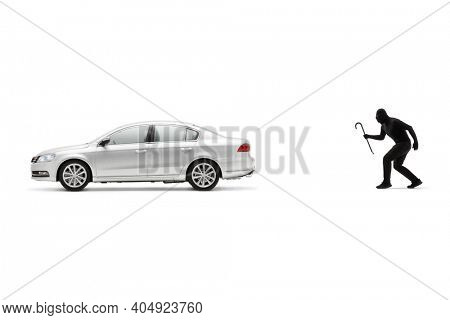 Car burglar with a crowbar walking towards a silver car isolated on white background