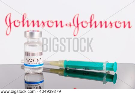 Johnson And Johnson Logo On The Background Of Bottle Or Vial With Vaccine And Syringe For Injection 