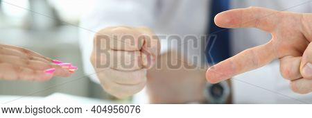 Close Up Of Table With Group Of People Playing Rock Paper Scissors Game In The Office. Rock, Paper, 