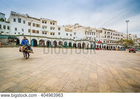 Moulay Idriss, Morocco - April 10, 2015. Man Riding On The Donkey In The Middle Of The Empty Main Sq