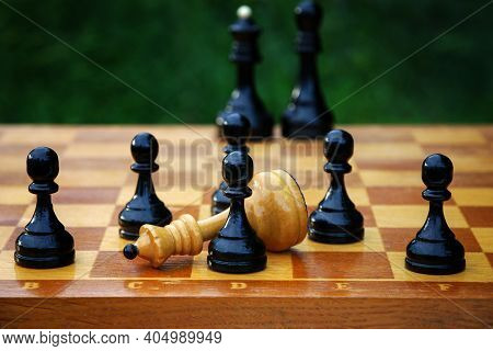 Chess End Game - Defeated White Chess Queen Surrounded By Black Pawns