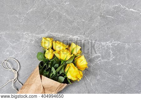 Yellow Roses In Recycled Craft Paper On Gray Background. Natural Aestetic. Valentines Day,mothers Da