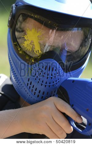 Young Children Playing Paintball In The Woods