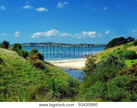 View Through A Hilly Landscape Onto A Beach