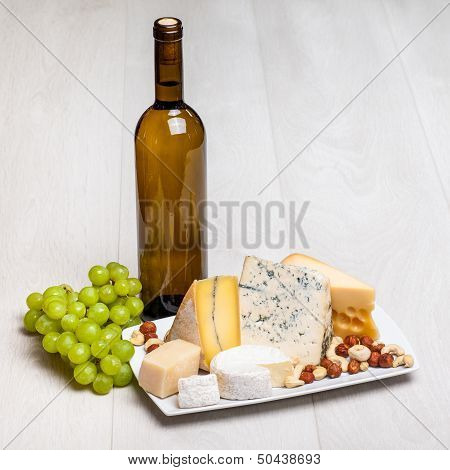 wine bottle and different kinds of cheese