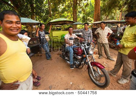 SIEM REAP, CAMBODIA - DEC 13: Unidentified cambodian moto-rickshaws in Angkor Wat, Dec 13, 2012 on Siem Reap, Cambodia. Angkor is the country's prime attraction for visitors.