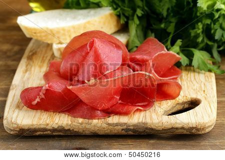 Smoked meat bresaola on a cutting board