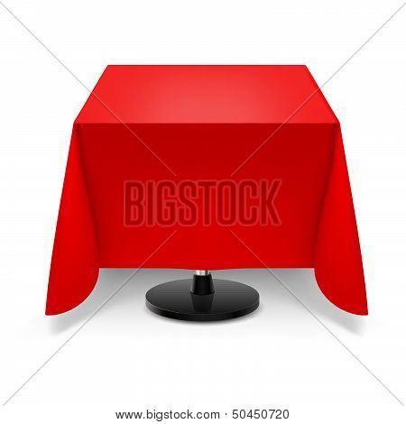 Square table with red tablecloth.