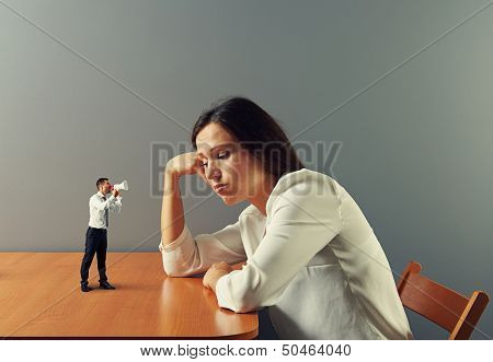 small man urge on tired businesswoman