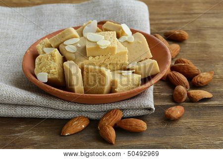 almond paste - marzipan in a bowl with whole nuts