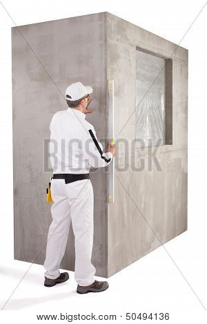 Worker Measuring With A Level Tool