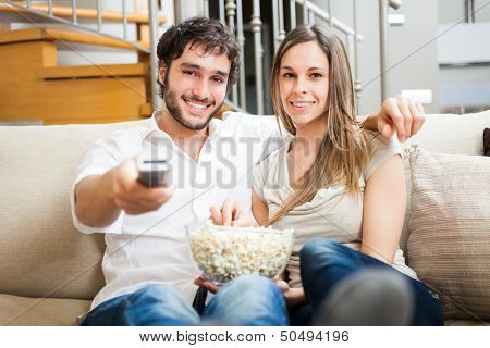 Young couple preparing to watch a movie