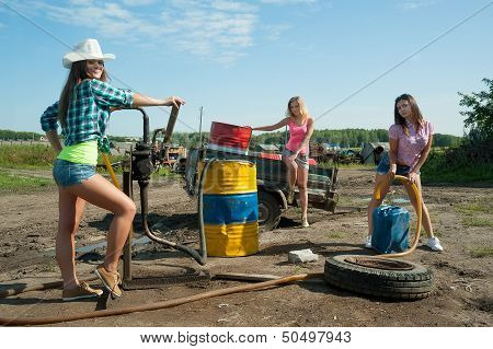young women on old gasoline station