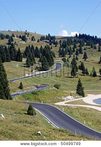 Ong And Winding Road Full Of Bends In The Meadows