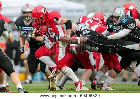 INNSBRUCK,  AUSTRIA - MAY 25 DB Chris James (#44 Raiders) tackles RB Alexander Kuronen (#36 Roosters) during the EFL football game on May 25, 2013 in Innsbruck, Austria.