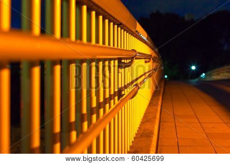 Balustrade of pedestrian foot bridge at night