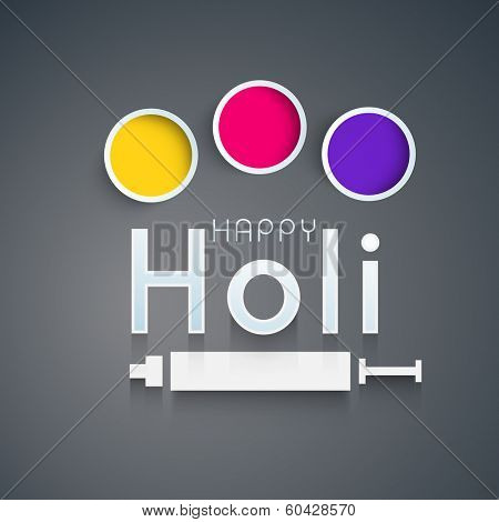 Indian festival Happy Holi celebrations concept with stylish text, colours and pichkari on grey background.