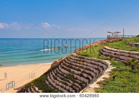 Artificial stone terrace with green grass and sand beach on Mediterranean sea in Ashkelon, Israel.
