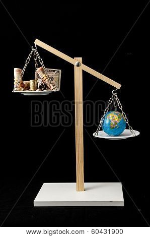 Earth and Money on a Two Pan Balance