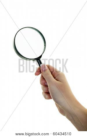 a hand holding a magnifying glass. viewed through the magnifying glass.