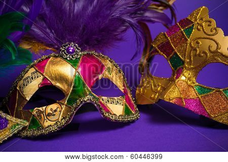 Festive Grouping of mardi gras, venetian or carnivale mask on a purple background