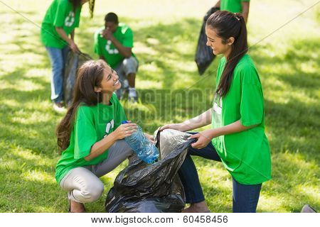 Team of young volunteers picking up litter in the park