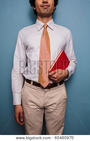 Young Man In Tie With A Red Book