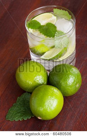 Mohito Cocktail Surrounded By Limes