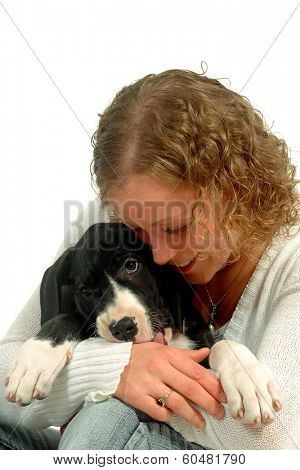Young woman is hugging her sweet puppy