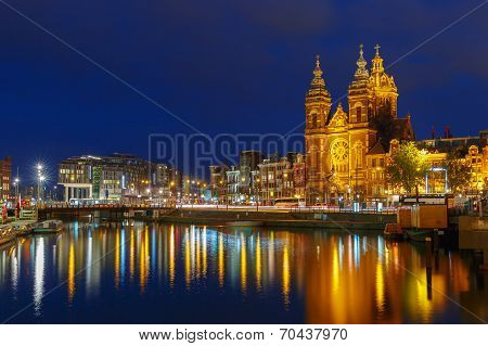 Night City View Of Amsterdam Canal And Basilica Of Saint Nicholas.