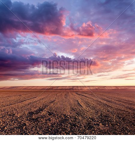 Cultivated Land And Cloud Formations At Sunset