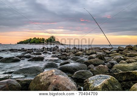 An Abandoned Fishing Pole Stands On The Seafront In St. Petersburg At Sunset