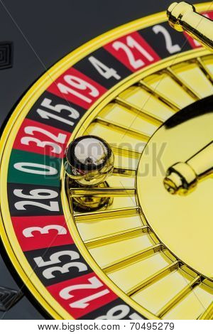 the cylinder of a roulette gambling in a casino. winning or losing is decided by chance. number zero, lost everything