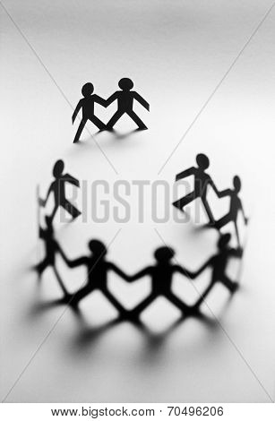 Paper dolls in circle with two bystanders