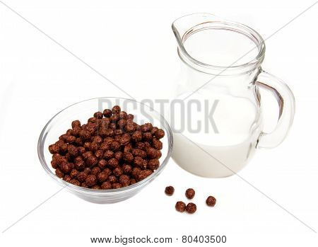 Bowl with chocolate cereals and milk jug