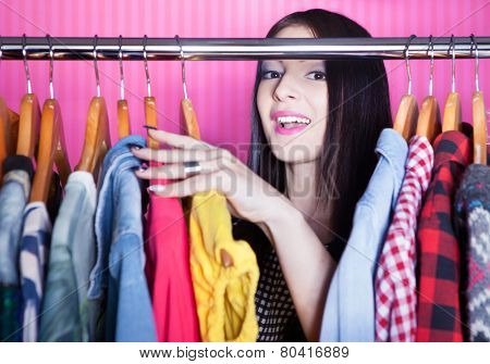 Time to refresh wardrobe young attractive surprised woman searching for clothing in a closet 