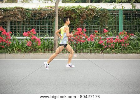 fitness marathon runners running on road