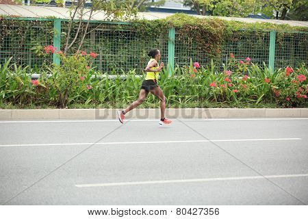 fitness marathon runners running on road