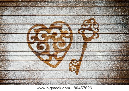Heart and a key of the flour as a symbol of love on wooden background.  Valentines day background.