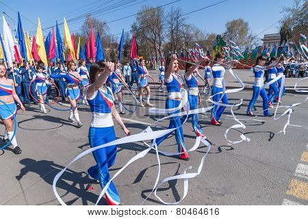 Attractive girls with gymnstics tapes on parade