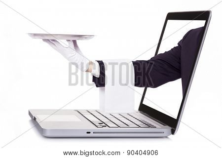 Waiter hand holding a silver tray through a laptop, isolated on white background
