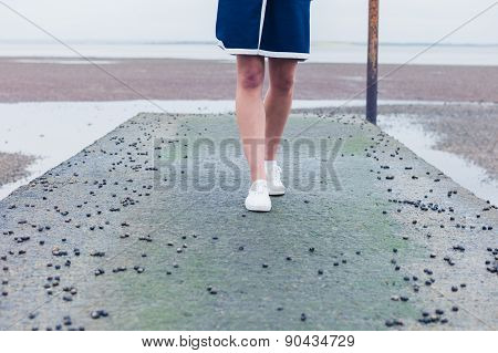 Woman Walking On Pier With Whelks