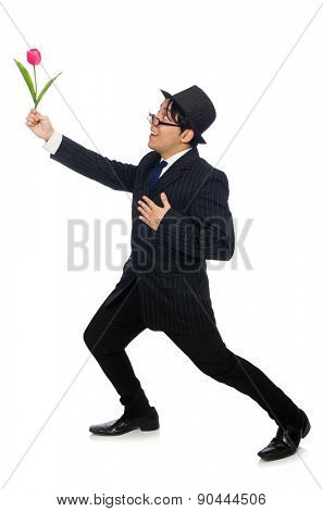 Young man in black costume with flower isolated on white