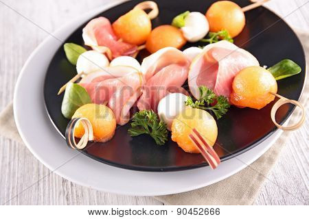 buffet food with melon,mozza and prosciutto