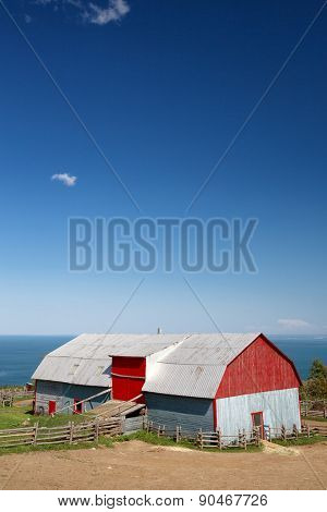 Traditional style tin barn overlooking the sea, La Malbaie, Quebec Province, Canada. Space for your text.