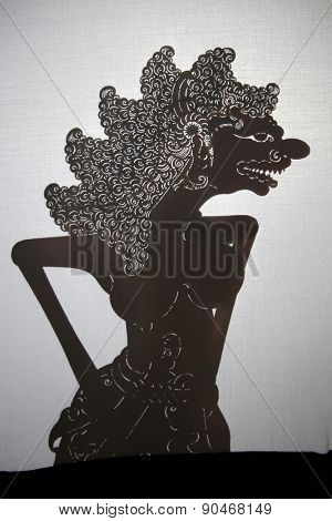 YOGYAKARTA, INDONESIA - AUGUST 14, 2012: Traditional Indonesian shadow puppet theatre wayang kulit performs on street during a religious festival in Yogyakarta, Central Java, Indonesia.