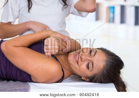 woman lying while getting a massage concept of physiotherapy