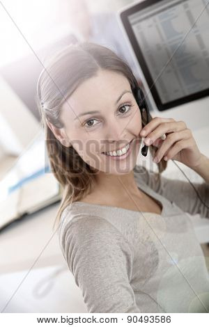 Beautiful smiling teleoperator with headset on 