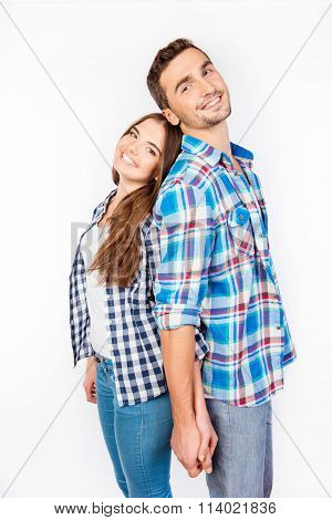 Portrait Of Young People Standing Back-toback Holding Hand In Hand