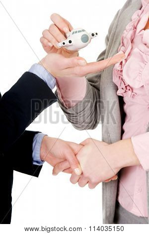 Businesswoman giving a plane to her partner.